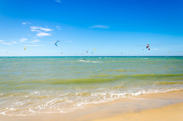 Several kite surfing on the air at the Cumbuco