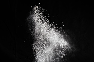 White powder. Grainy abstract texture on black background.