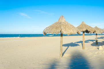 Many sun umbrellas at the beach sand