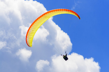 paraglider in front of the clouds