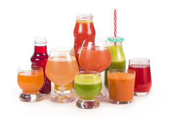 Glasses with fresh organic vegetable and fruit juices isolated on white.