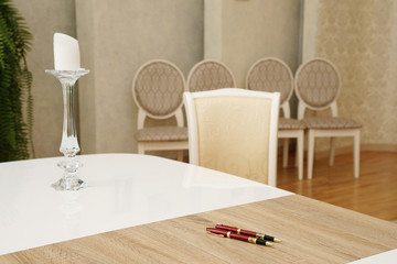 Table with candlestick and candles, pens and chair