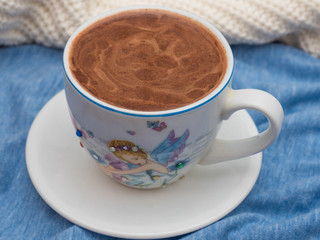 Cup of cocoa with foam on the table