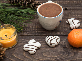 Cup of cocoa with foam and gingerbread on a wooden table