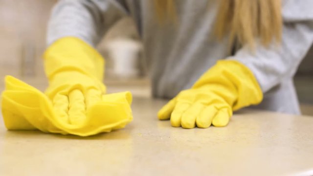 Girl clean table with rag