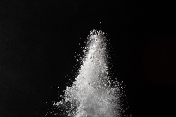 White powder. Grainy abstract texture on black background.