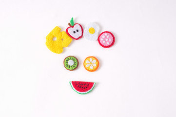 Toys in the form of food and fruits hand made of felt on a white background. Hand sewing
