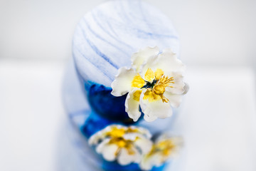 Multilevel blue wedding cake with flowers