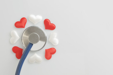 Healtcare concept: stethoscope and fabric hearts in a flower shape