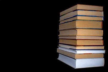 a stack of books on a black background