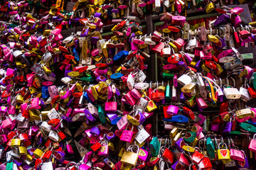 Fototapeta na wymiar Many colourful love padlocks at the wall of Juliet's house, Verona, Italy