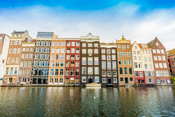 Naklejka premium Canal houses of Amsterdam, Netherlands. Traditional old buildings in Amsterdam