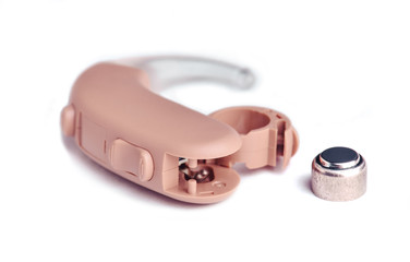 Hearing aid close up on white background with batteries