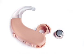 Hearing aid close up on white background with batteries