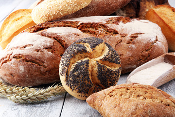 Different kinds of bread and bread rolls on white board. Kitchen or bakery poster design