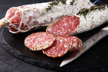 Marble cutting board with sliced salami on it
