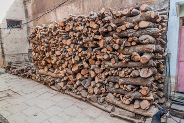 Piles of fire wood used for ghat cremations in Varanasi, India