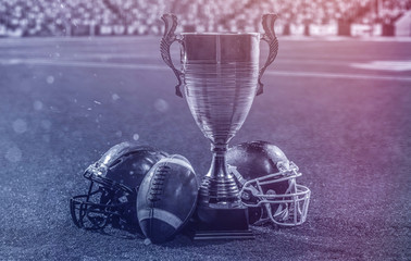 closeup of american football,helmets and trophy