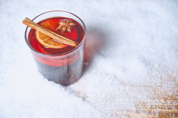 mulled wine on a snow-covered wooden table