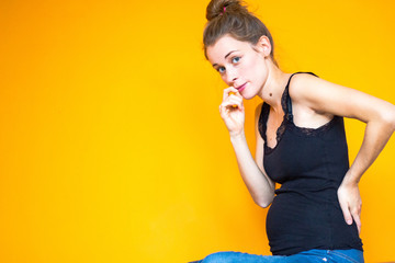 happy pregnant woman sitting on the floor