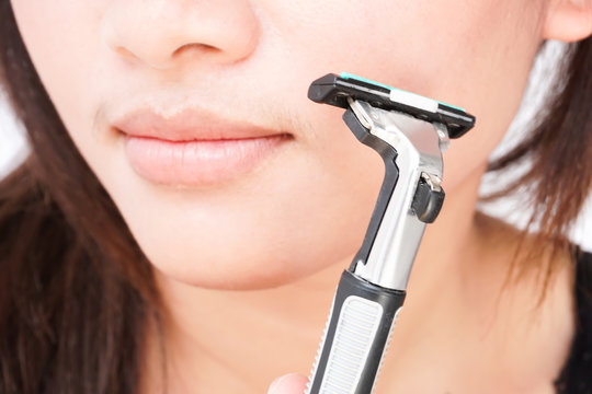 Closeup woman hand holding razor pre for shaving face, health care and beauty concept, selective focus