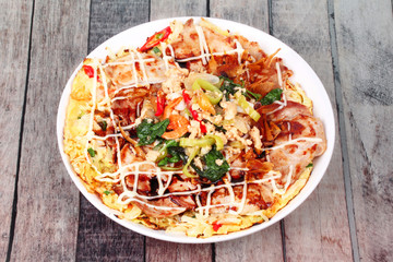 Homemade Japan pizza topped fried spicy basil with minced pork.