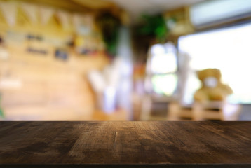 Empty wooden table in front of abstract blurred background of coffee shop . can be used for display or montage your products.Mock up for display of product.