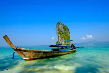 Gordijnen Concept of travel and relax. Beautiful local fishing boats on sea   with blue sky and clouds , Railay beach, Krabi Thailand © iphotothailand