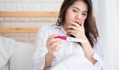 Selective focus Pregnancy test positive result on hand of  woman ,have morning sickness  pregnant...