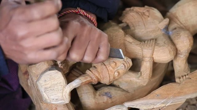 MANDALAY, MYANMAR - Burmese man are making wooden souvenirs for tourists. Wood Carving is a traditional handicraft in Myanmar