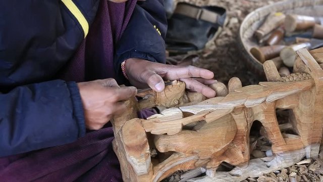 MANDALAY, MYANMAR -  Burmese man are making wooden souvenirs for tourists. Wood Carving is a traditional handicraft in Myanmar