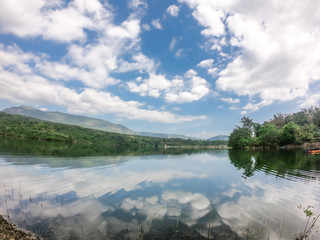 Coulds and mountains reflex on the lake