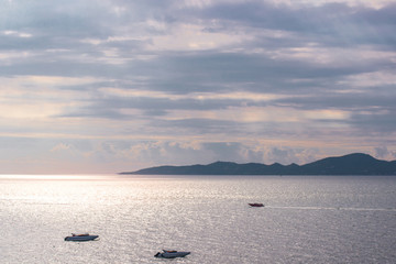 Boats in the sea while sunset making two tone sky
