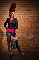 Punk girl on brick wall background