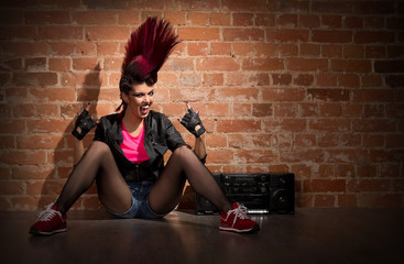 Punk girl on brick wall background