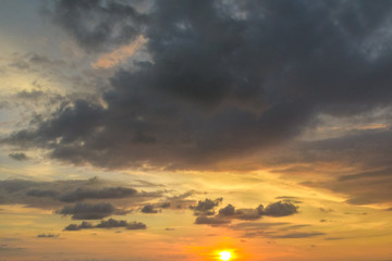 Beautiful colorful sunset with dramatic clouds and sun shining