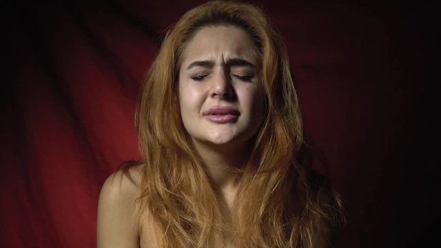 Beautiful red-haired woman shows how frustrated she is and disappointed 