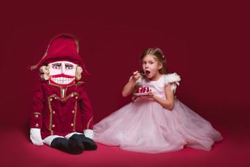 The beauty ballerina standing with nutcracker
