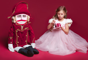 The beauty ballerina standing with nutcracker