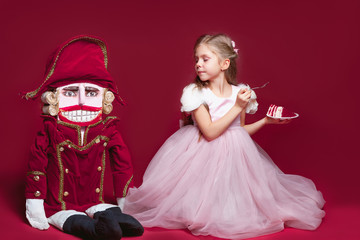 The beauty ballerina standing with nutcracker