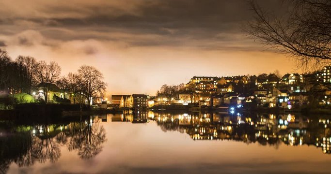 TRONDHEIM, NORWAY &ndash; FEBRUARY,2017 : Amazing timelapse of clouds moving over Trondheim cityscape at night with reflections on water in view