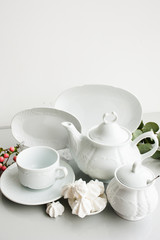 Expensive porcelain tea set on white background. Proper quality dishes concept