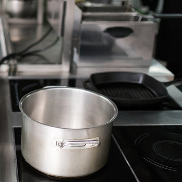 Saucepan and other kitchen utensils in professional restaurant. Chef's little helpers