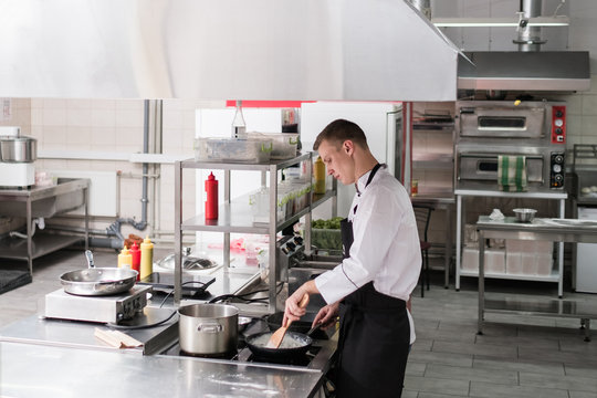 Restaurant kitchen interior. Workspace of talented and successful cooks. Clean and tidy working surfaces