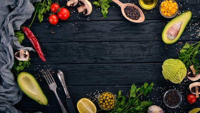 Preparation for cooking. Avocados, cherry tomatoes, green peas and hazelnut. On a wooden background. Top view. Free space for your text.