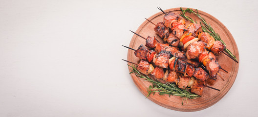 Marinated baked kebab with onions and spices. On a wooden background. Top view. Free space for text.
