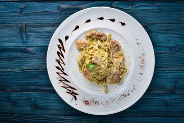 Pasta with white mushrooms and cream sauce. Tagliateli Italian cuisine. Free space for your text. Top view.