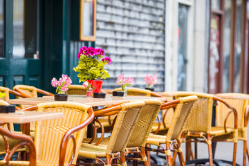 Outdoor cafe on a street of typical greek traditional village in Greece. Coffee on table for breakfast