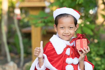 Asian happy girls in santa claus hats with gift box.Christmas Xmas  concept