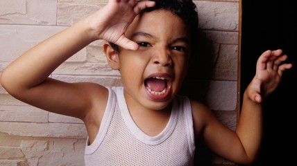 Child making scary face to frighten people